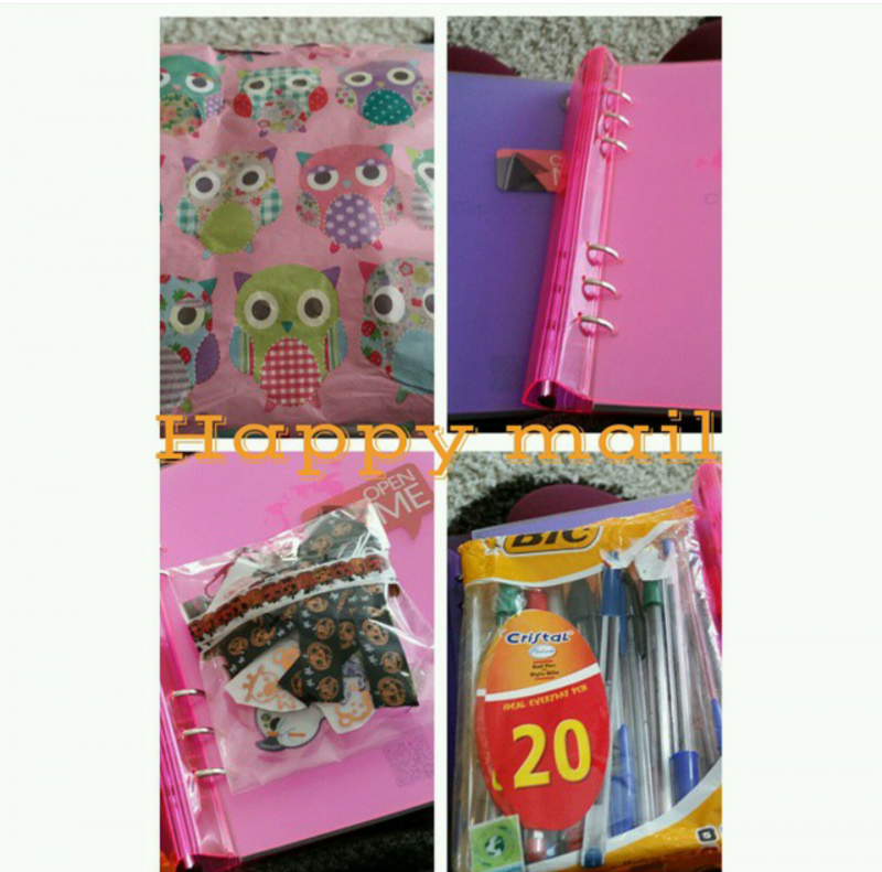 Pink Filofax-style planner with colourful inserts and stationery