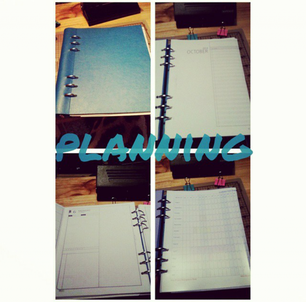 Teal Filofax-style planner decorated with colourful stationery and owl accessories