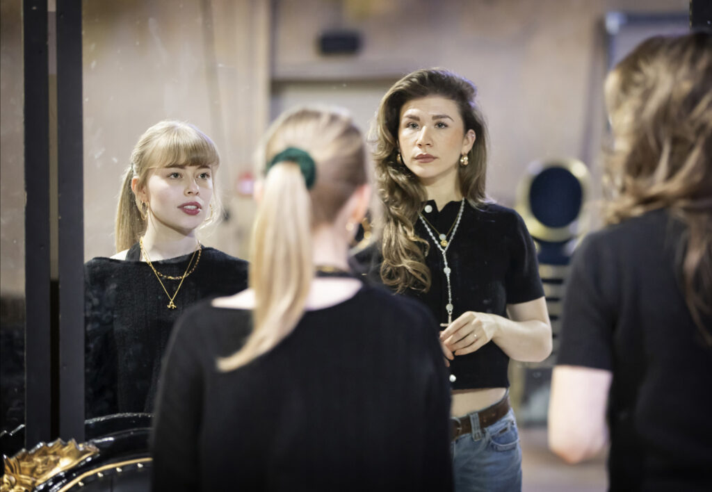 Abbie Budden (Annette) and Nic Myers (Kathryn) in rehearsals - Pamela Raith Cast of Cruel Intentions: The '90s Musical UK and Ireland tour rehearsing an intense scene with dramatic lighting.