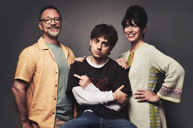 Joshua Malina, Gabriel Howell, and Caroline Catz posing for a promotional photo, exuding contrasting emotions of seriousness and casual warmth.