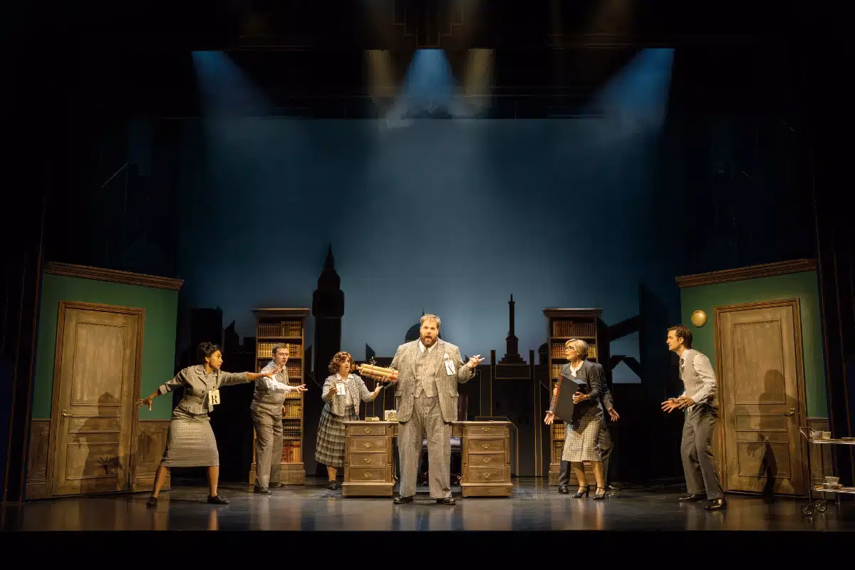 The Comedy About Spies company performing on stage at the Adelphi Theatre