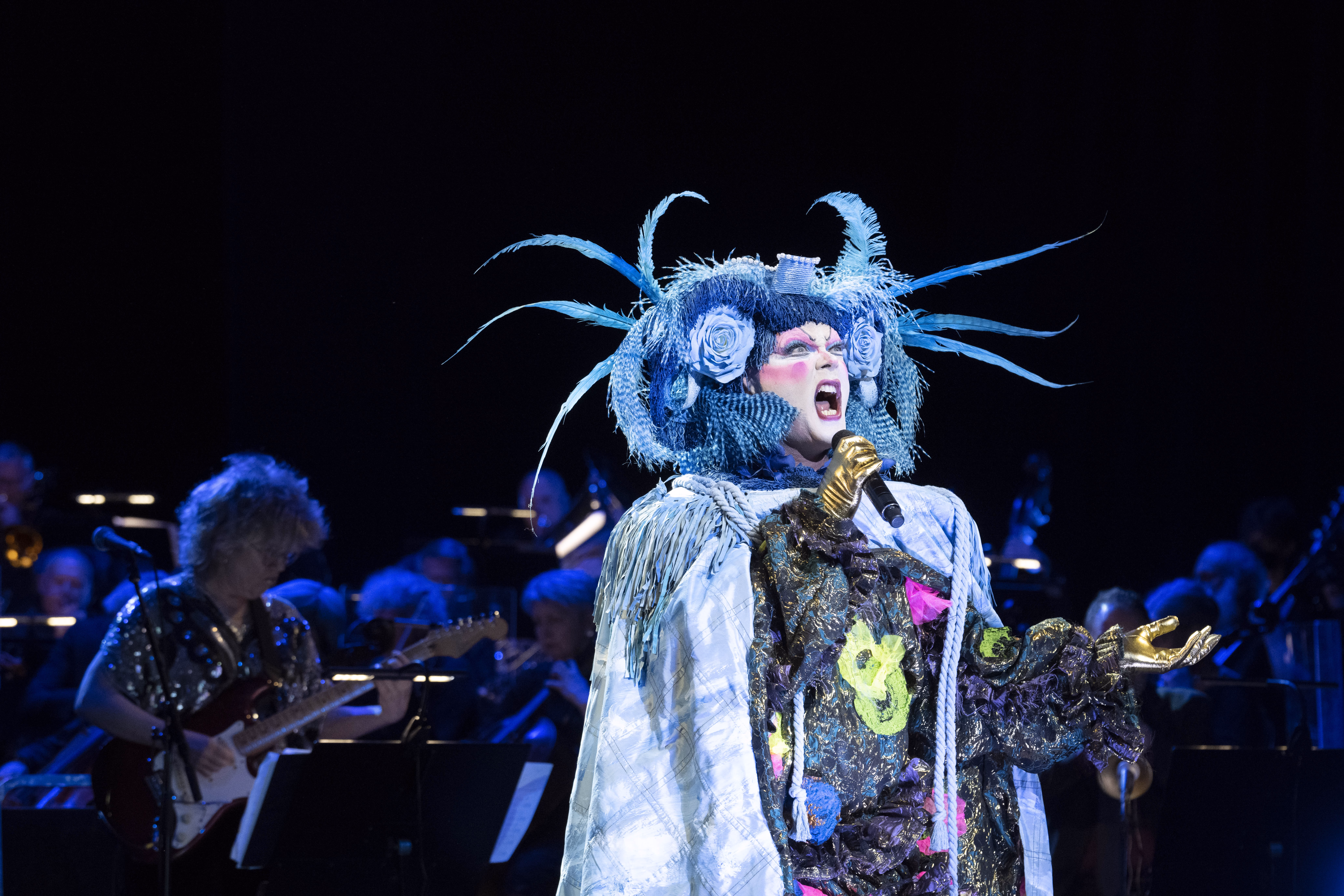 Taylor Mac performing in a blue theatrical costume